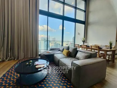 Luxurious high-rise living room with stunning city view and modern decor.