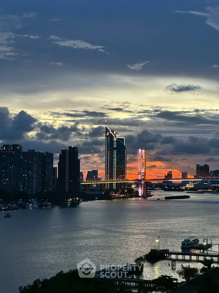 Stunning cityscape view with illuminated bridge and skyline at dusk, perfect for urban living enthusiasts.