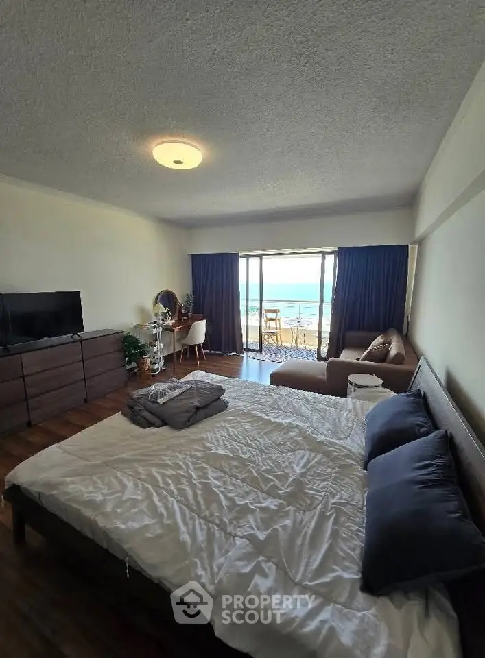 Spacious bedroom with ocean view and modern furnishings
