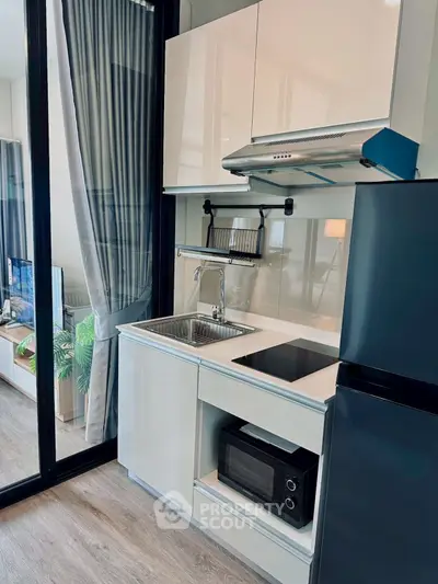 Modern compact kitchen with sleek appliances and open layout design