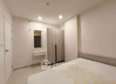 Modern bedroom with minimalist design, featuring a large wardrobe and cozy lighting.
