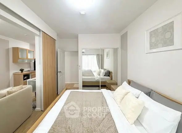 Modern bedroom with mirrored closet and cozy decor in a stylish apartment.