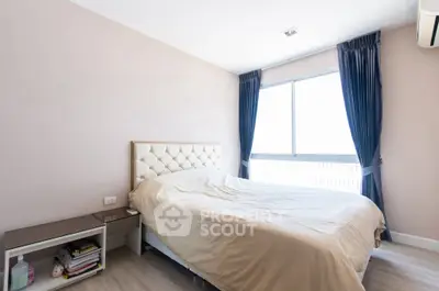 Bright and cozy bedroom with elegant headboard and large window view.
