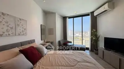 Modern bedroom with city view, featuring stylish decor and natural light.