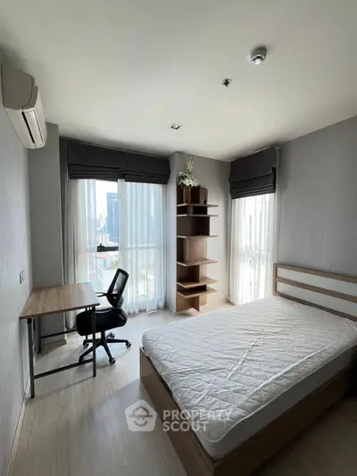 Modern bedroom with city view, featuring a study desk and minimalist decor.