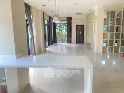 Spacious open-plan living area with large windows and modern design