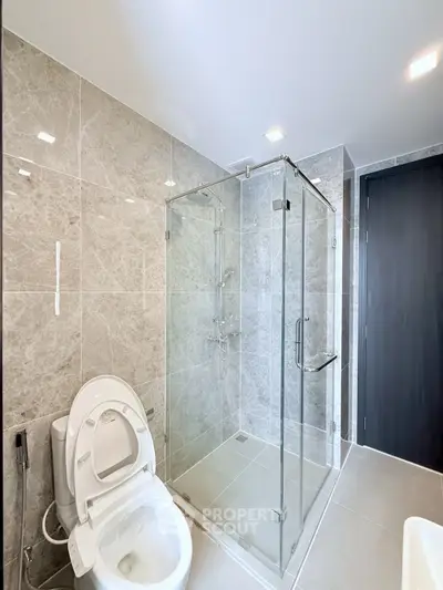 Modern bathroom with glass shower and sleek tile design