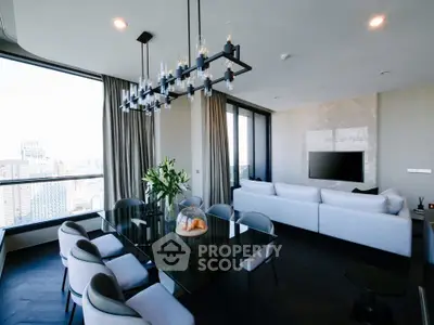 Luxurious modern living room with city view, elegant chandelier, and stylish furniture.
