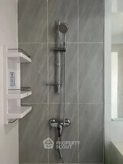 Modern bathroom shower with sleek gray tiles and chrome fixtures