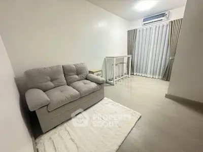 Modern living room with cozy sofa and stylish bar table near window with curtains.