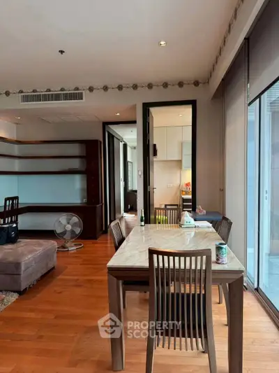 Spacious living room with elegant dining area and wooden flooring