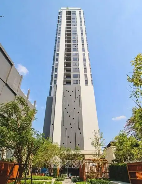 Stunning high-rise building with modern architecture and lush greenery