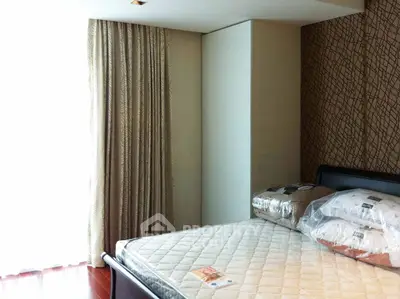 Spacious bedroom with modern decor and natural light