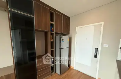 Modern kitchen with sleek cabinetry and stainless steel fridge