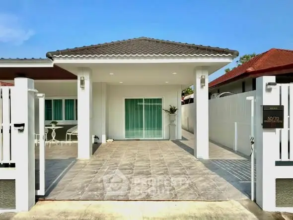 Charming single-story home with tiled driveway and inviting entrance, perfect for modern living.