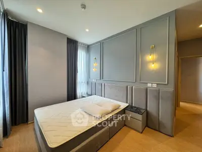 Modern bedroom with stylish lighting and elegant decor, featuring a comfortable bed and soft lighting.