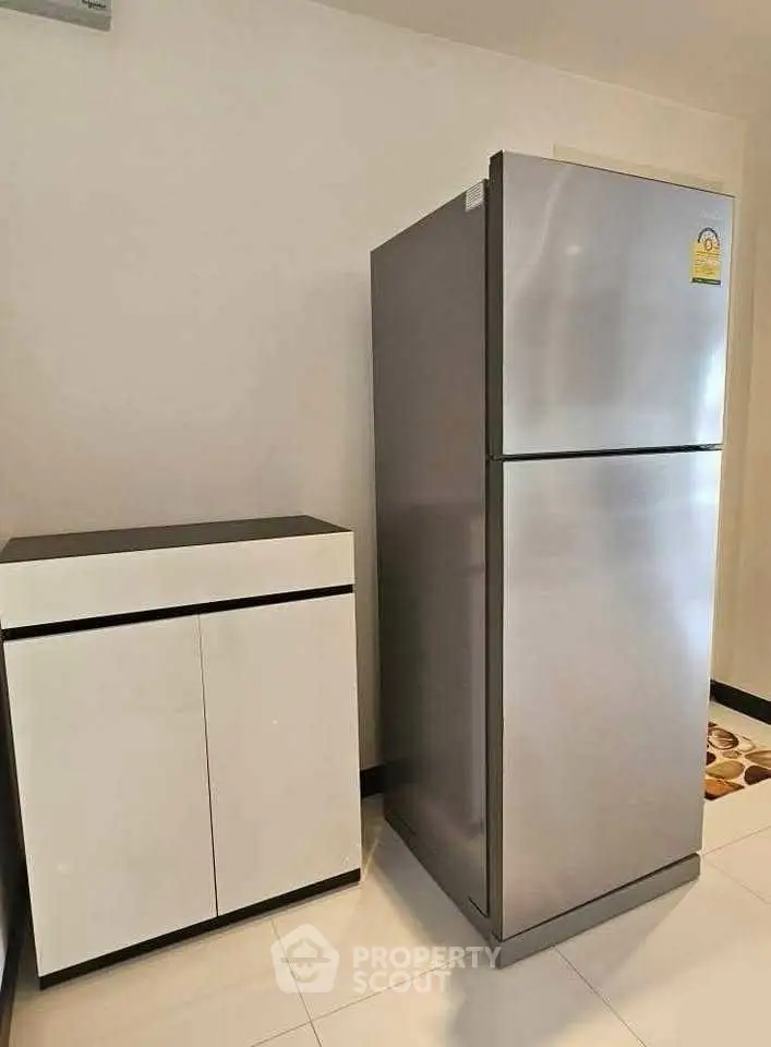 Modern kitchen with sleek refrigerator and storage cabinet