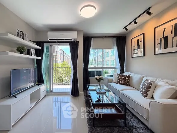 Modern living room with sleek decor and balcony view in urban apartment.