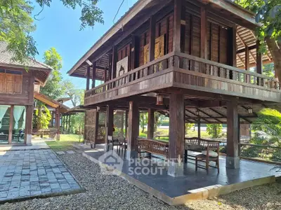 Charming traditional wooden house with elevated design and spacious outdoor area, perfect for serene living.