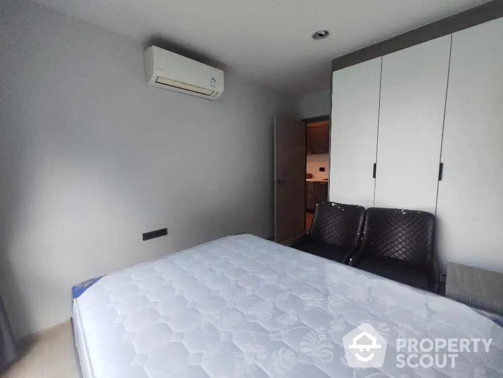 Modern bedroom with air conditioning and built-in wardrobe