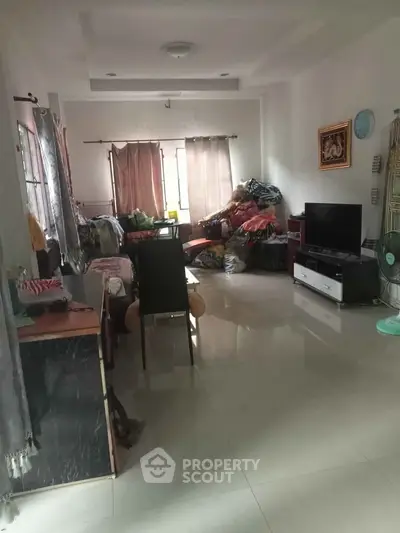 Spacious living room with modern decor and ample natural light, ideal for family gatherings.