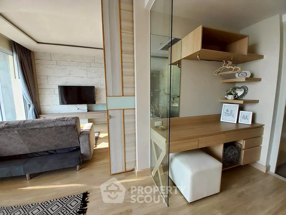 Modern living room with stylish decor and open layout, featuring a cozy seating area and elegant wooden accents.