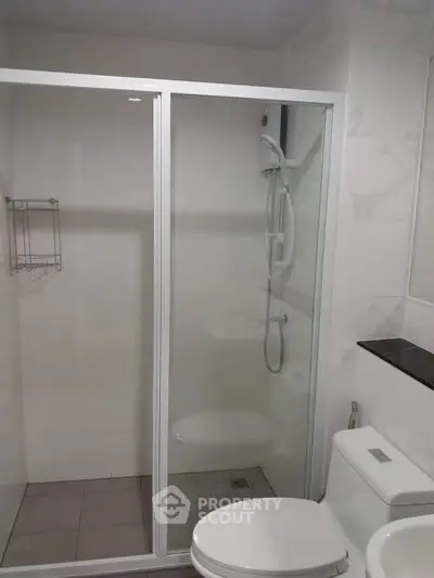 Modern bathroom with glass shower enclosure and sleek fixtures