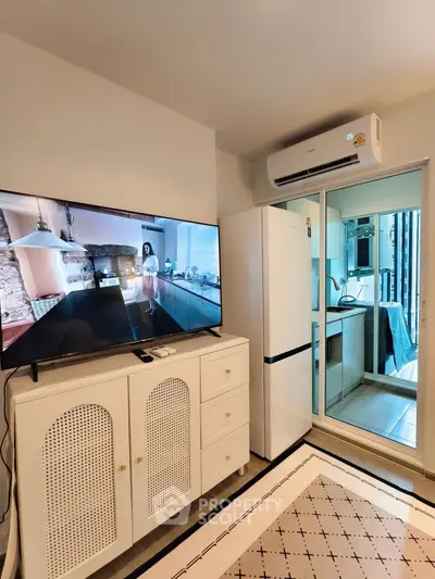Modern living room with TV, air conditioner, and stylish cabinet