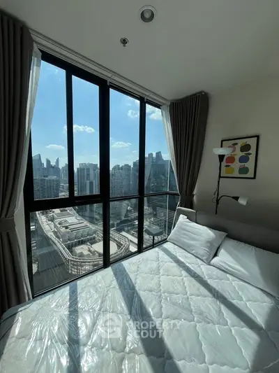 Luxurious bedroom with stunning city view from floor-to-ceiling windows