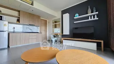 Modern open-layout living room with sleek kitchen and stylish decor