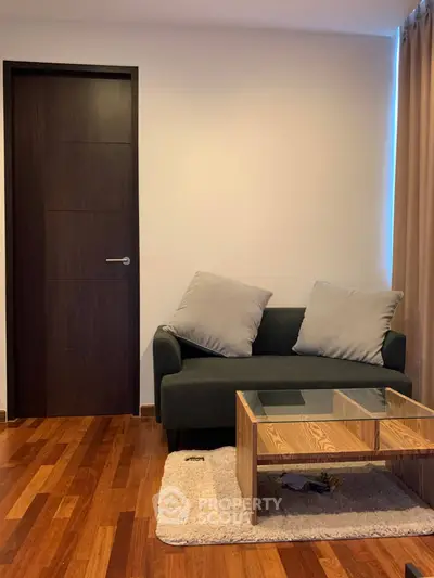 Cozy living room with modern sofa and wooden coffee table on polished hardwood floor.