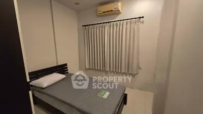 Cozy minimalist bedroom with air conditioning and simple decor