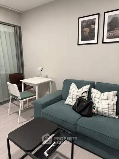 Cozy living room with teal sofa and modern decor in stylish apartment
