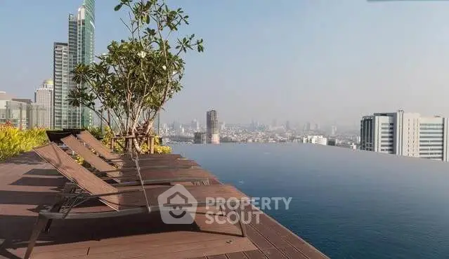 Luxurious rooftop infinity pool with stunning city skyline view, perfect for relaxation and leisure.
