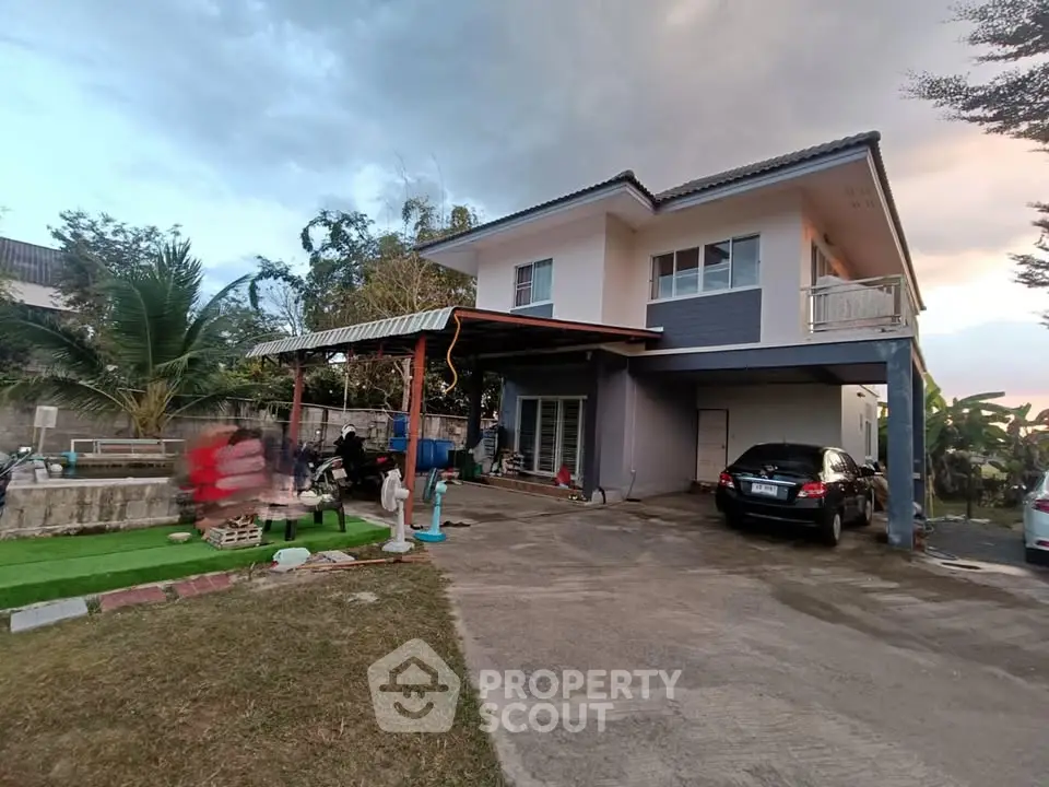 Charming two-story house with spacious driveway and lush garden
