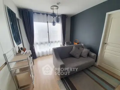 Cozy living room with modern gray sofa and stylish decor in a bright apartment.