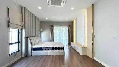 Spacious modern bedroom with elegant design and natural light.