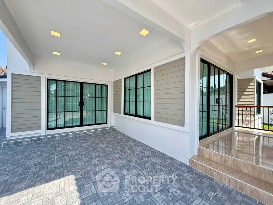 Spacious modern entrance with elegant tiled flooring and large windows