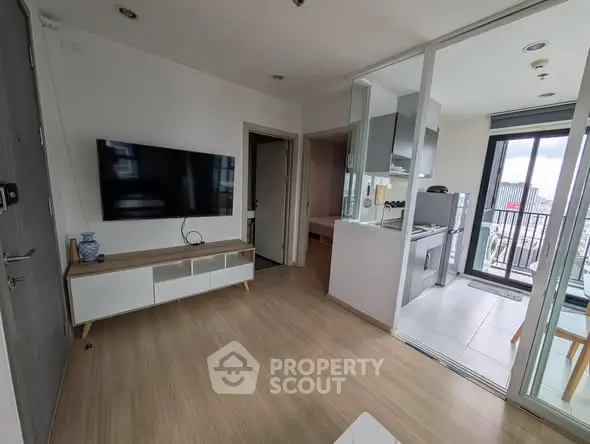 Modern apartment living room with open kitchen and balcony view