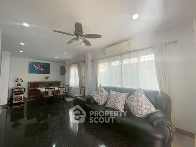 Spacious living room with elegant decor and ample natural light