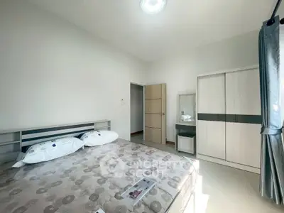 Bright and airy bedroom with modern furnishings and ample natural light.