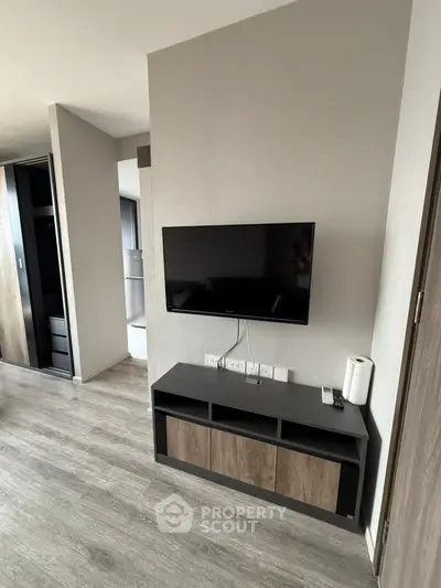Modern living room with wall-mounted TV and sleek storage unit