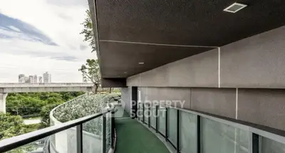 Modern architectural balcony with sleek design and city view.