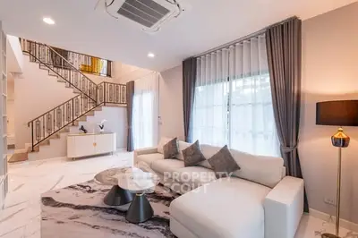 Luxurious living room with elegant staircase and modern decor