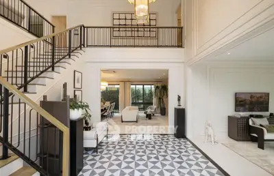 Luxurious open-plan living room with elegant staircase and modern decor
