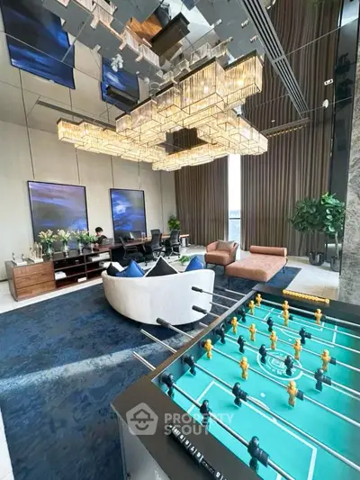 Luxurious living room with modern decor and foosball table, perfect for entertainment and relaxation.