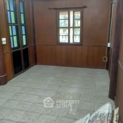 Cozy empty room with wooden walls and tiled floor, perfect for customization.