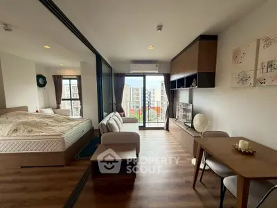 Modern studio apartment with open layout, featuring a cozy living area, stylish bedroom, and balcony with city view.