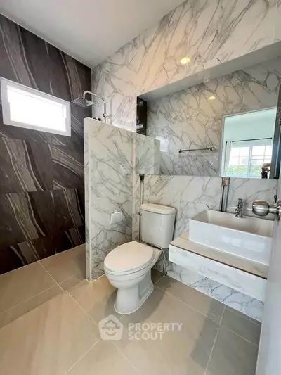 Modern bathroom with marble walls and sleek fixtures