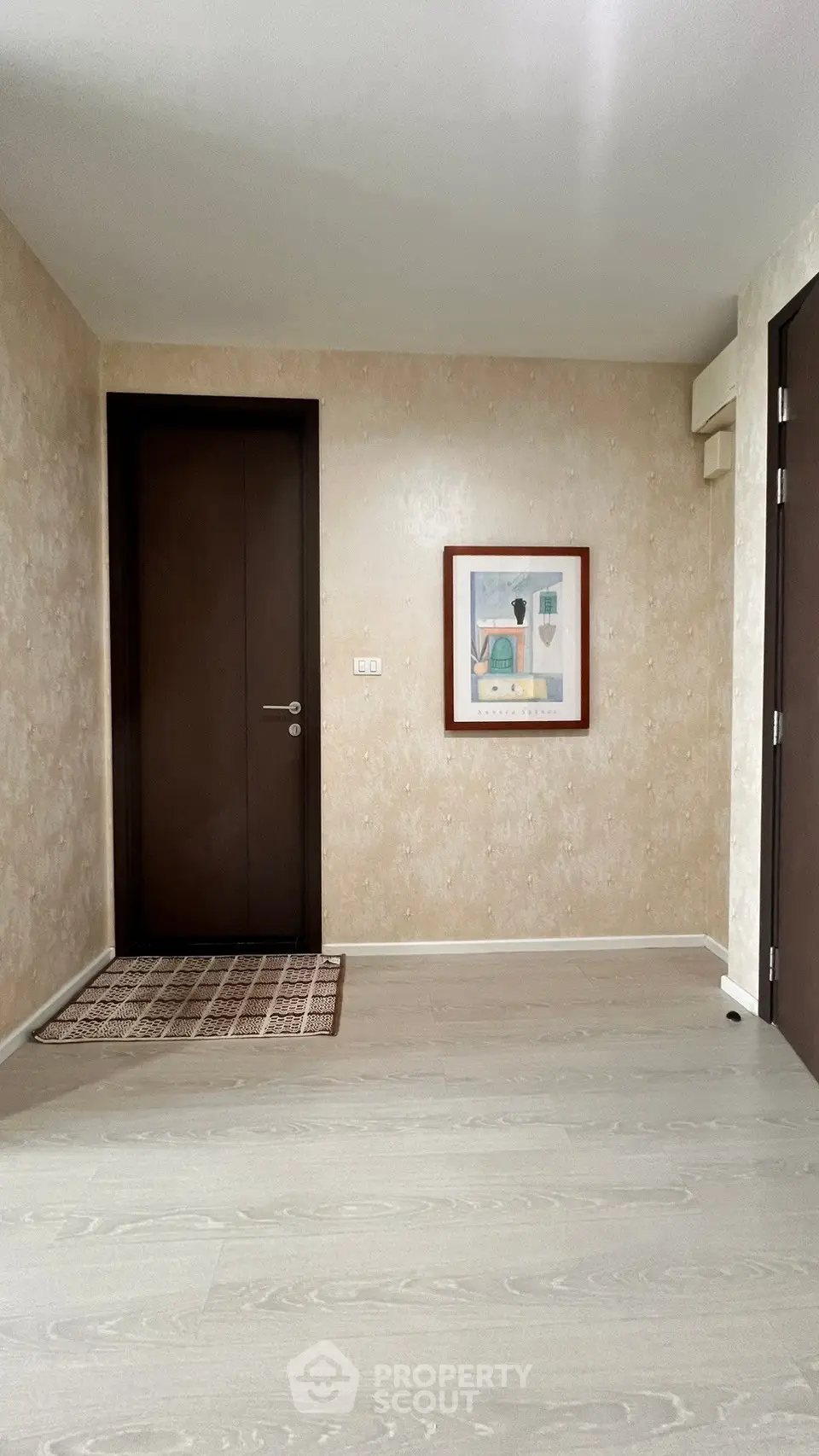 Spacious entryway with modern decor and wooden flooring